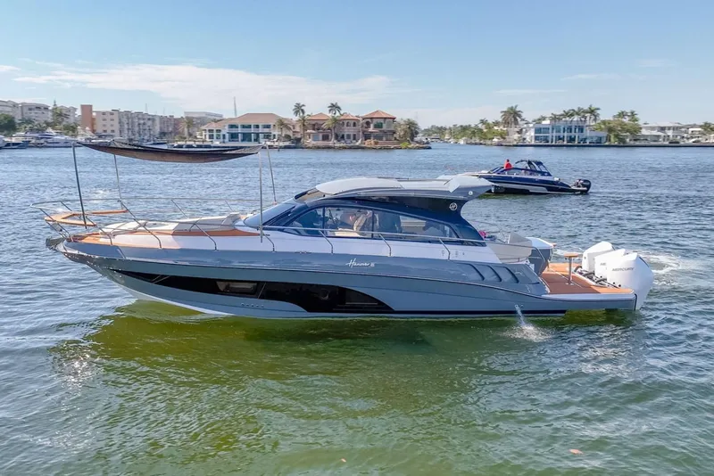 The Image of Manufacturer Provided Image: 2025 Hanover 415 yacht cruising on a sunny day near waterfront homes. - 0