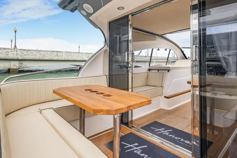 Slide: The Image of Manufacturer Provided Image: Luxurious 2025 Hanover 415 yacht interior with elegant seating and wooden table. - 14