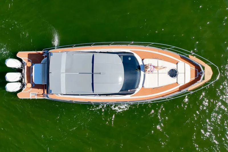 Slide: The Image of Manufacturer Provided Image: Top view of 2025 Hanover 415 yacht cruising on green water. - 3