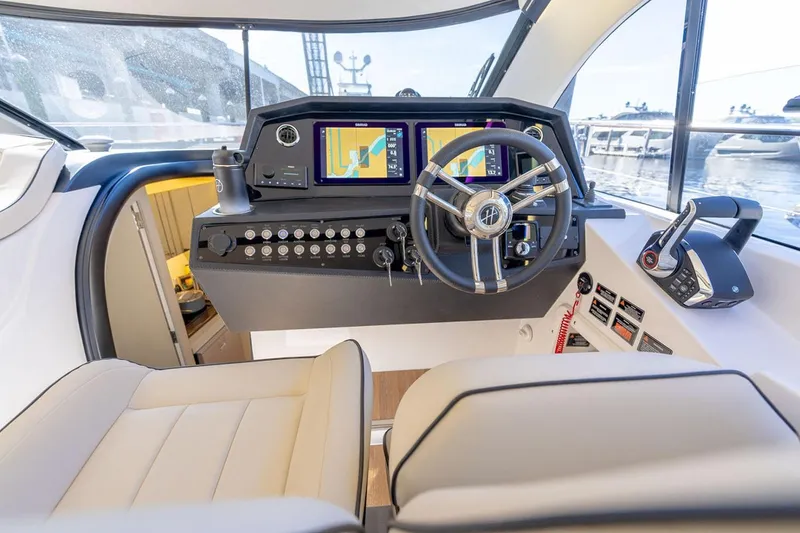 Slide: The Image of Manufacturer Provided Image: Luxurious 2025 Hanover 415 yacht cockpit with advanced navigation system and plush seating. - 7