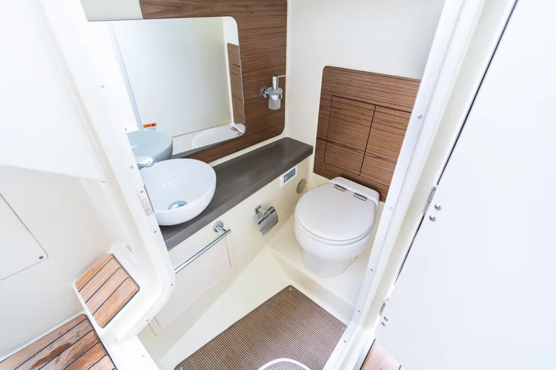 Slide: The Image of Luxurious bathroom interior of 2025 Chris-Craft Launch 31 GT boat, featuring modern fixtures and wood accents. - 10