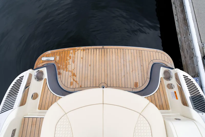 Slide: The Image of 2025 Chris-Craft Launch 31 GT boat deck with elegant wood finish by the water. - 12