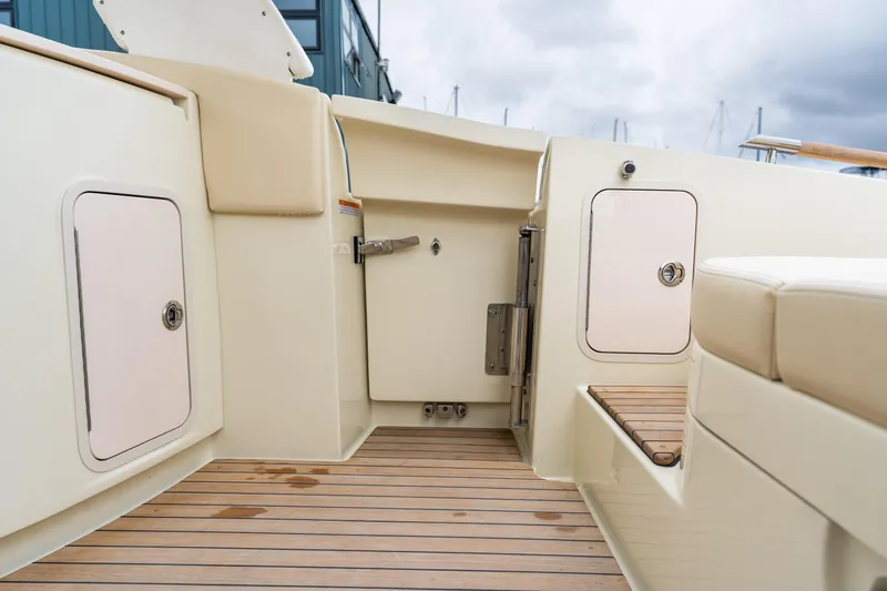 Slide: The Image of Interior view of 2025 Chris-Craft Launch 31 GT boat with teak flooring and storage compartments. - 19