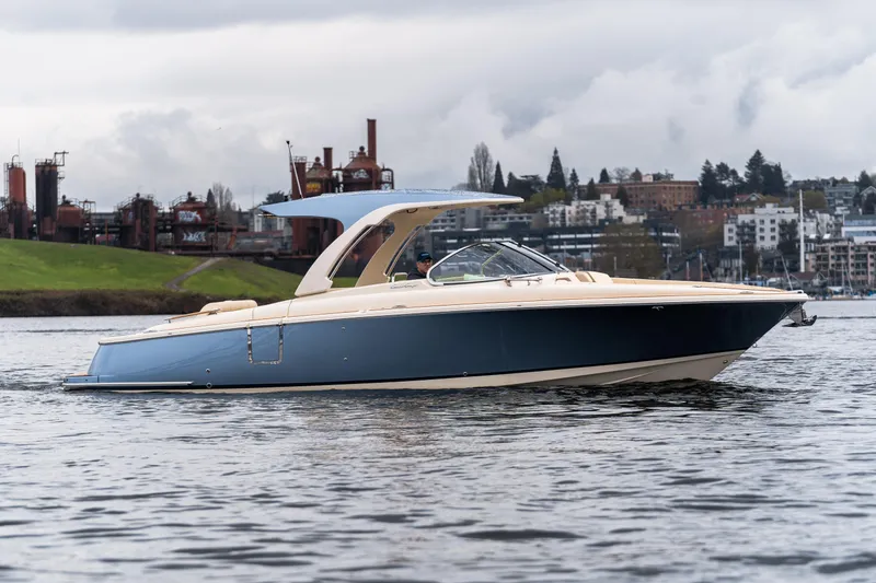 Slide: The Image of 2025 Chris-Craft Launch 31 GT boat on water, urban industrial background. - 4