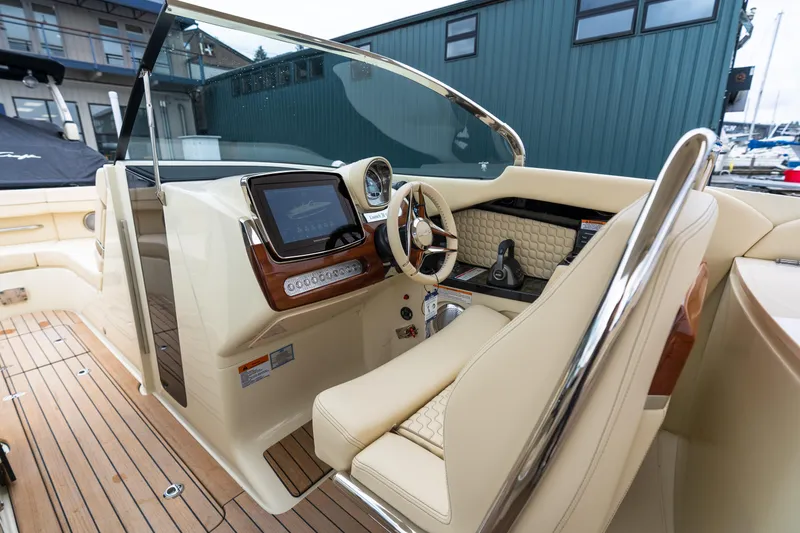 Slide: The Image of 2025 Chris-Craft Launch 31 GT boat interior with luxurious dashboard and steering wheel. - 6