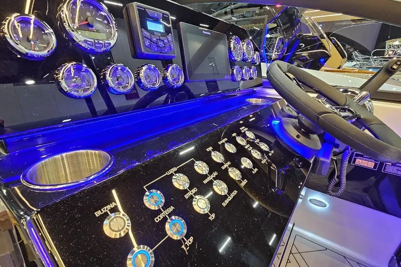 Slide: The Image of Control panel of a 2027 Hanover 327 boat with illuminated gauges and steering wheel. - 10