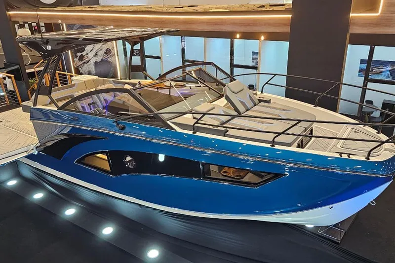Slide: The Image of 2027 Hanover 327 boat showcased in a modern indoor exhibition setting. - 23