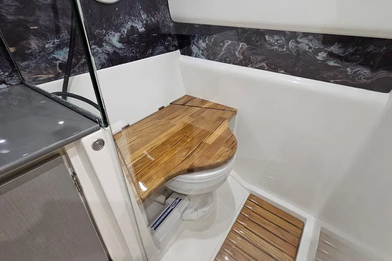 Slide: The Image of Modern bathroom in 2027 Hanover 327 model with wooden toilet cover and sleek design. - 26