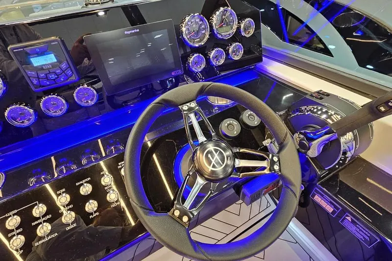 Slide: The Image of Control panel of a 2027 Hanover 327 boat with illuminated gauges and steering wheel. - 34