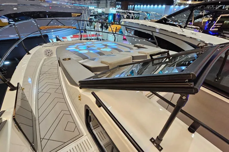 Slide: The Image of Luxurious 2027 Hanover 327 yacht with sleek design and modern deck features at a boat show. - 36