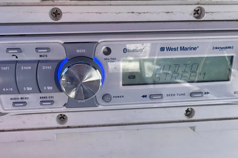 Slide: The Image of West Marine audio system on 2009 Boston Whaler 150 Montauk boat dashboard. - 10