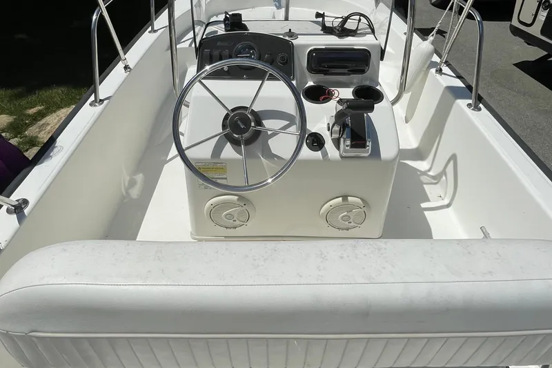 Slide: The Image of 2009 Boston Whaler 150 Montauk boat interior with steering wheel and controls. - 5