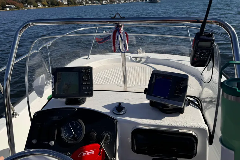 Slide: The Image of 2009 Boston Whaler 150 Montauk dashboard with navigation equipment on a sunny day. - 7