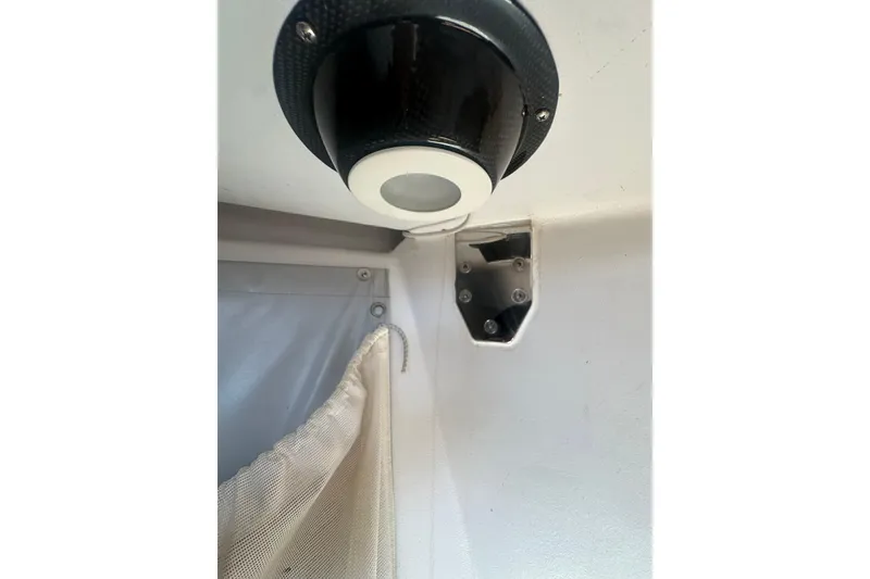 Slide: The Image of Interior detail of a 2006 Maxi Dolphin Cross Current 33 yacht, featuring a light fixture and curtain. - 17