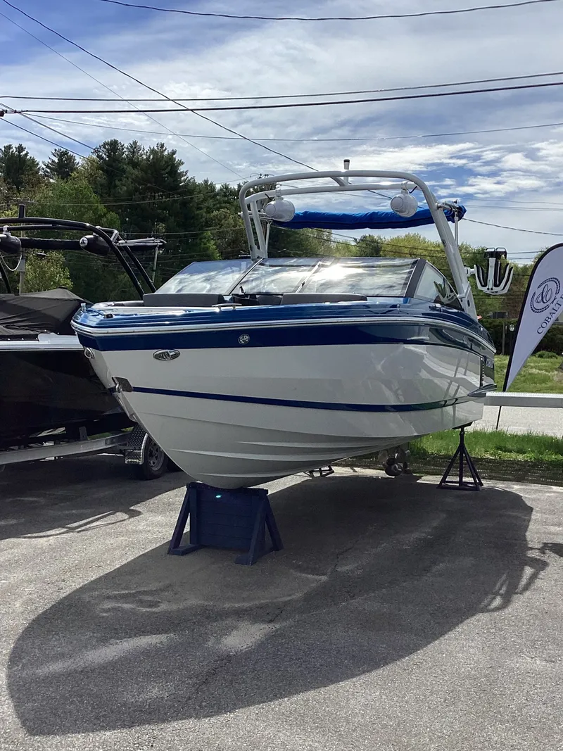 The Image of 2026 Cobalt R4 Surf boat displayed in a parking lot. - 1