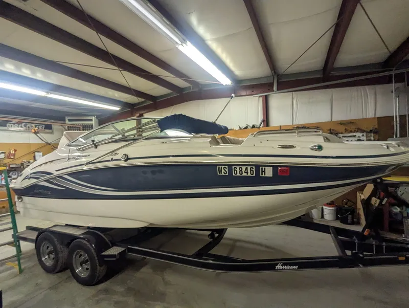 The Image of 2013 Hurricane SD2200-IO boat on trailer in warehouse. - 1