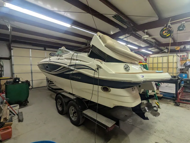 Slide: The Image of 2013 Hurricane SD2200-IO boat in a workshop on a trailer. - 2