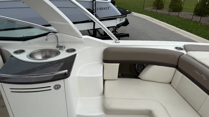 Slide: The Image of Interior of a 2013 Sea Ray 270 SLX with sink and seating area. - 12