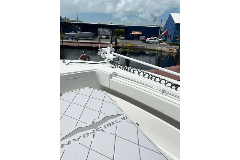 Slide: The Image of 2021 Invincible 33 Open Fisherman boat docked at marina under cloudy sky. - 12