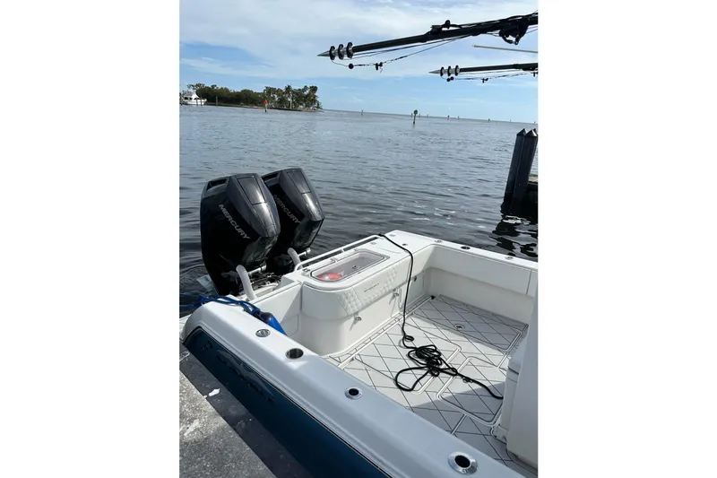 Slide: The Image of 2021 Invincible 33 Open Fisherman boat with dual Mercury engines docked by the water. - 13