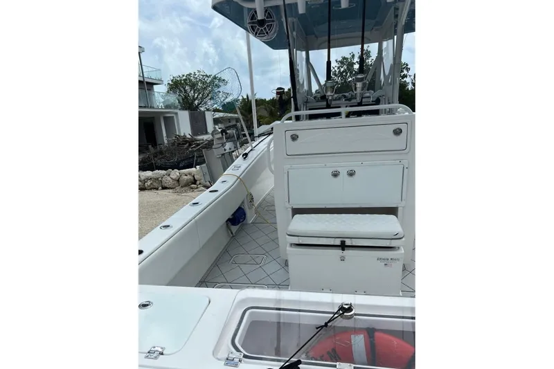Slide: The Image of 2021 Invincible 33 Open Fisherman boat interior with fishing gear and storage compartments. - 14