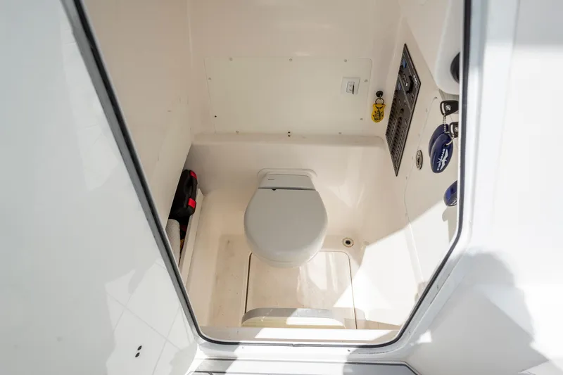 Slide: The Image of 2021 Invincible 33 Open Fisherman boat interior with compact marine toilet. - 20