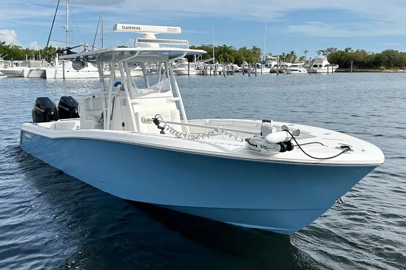 Slide: The Image of 2021 Invincible 33 Open Fisherman boat on water, featuring dual engines and advanced navigation equipment. - 3