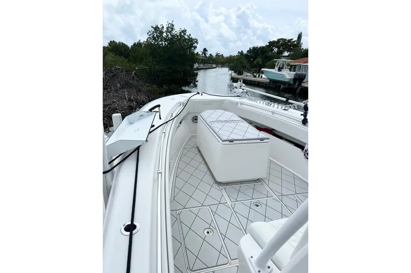 Slide: The Image of 2021 Invincible 33 Open Fisherman boat docked by a scenic waterway. - 8