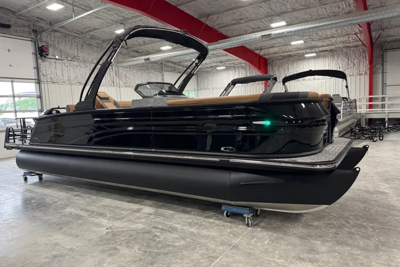 The Image of 2026 Sylvan L5 DLZ pontoon boat in a showroom, showcasing sleek black design. - 1