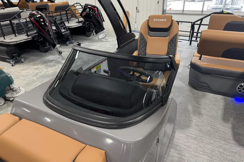Slide: The Image of 2026 Sylvan L5 DLZ boat interior with tan seating and modern dashboard design. - 11