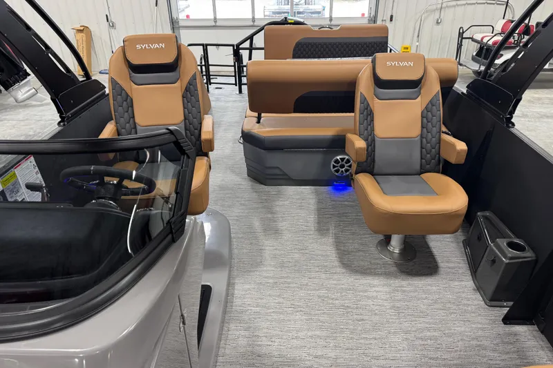 Slide: The Image of Interior of 2026 Sylvan L5 DLZ boat with tan and gray seating. - 12