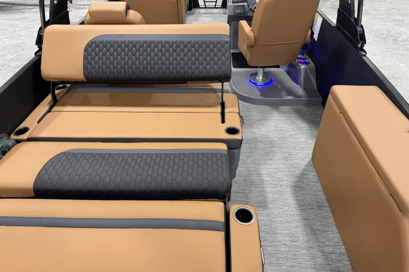 Slide: The Image of Luxurious interior of 2026 Sylvan L5 DLZ boat with tan and gray seating. - 14