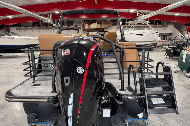 Slide: The Image of 2026 Sylvan L5 DLZ pontoon boat in showroom, featuring sleek design and powerful engine. - 6