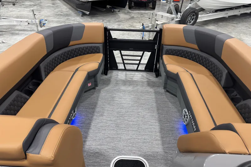 Slide: The Image of Luxurious interior of 2026 Sylvan L5 DLZ pontoon boat with tan and gray seating. - 8