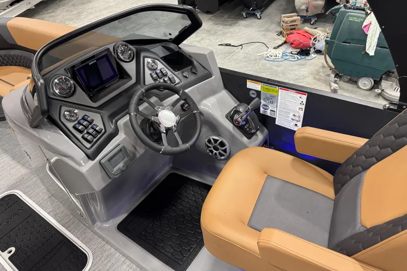 Slide: The Image of 2026 Sylvan L5 DLZ boat cockpit with modern controls and tan seating. - 9