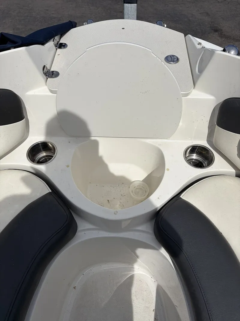 Slide: The Image of Interior of a 2018 Stingray 195 LX boat with seating and cup holders. - 11