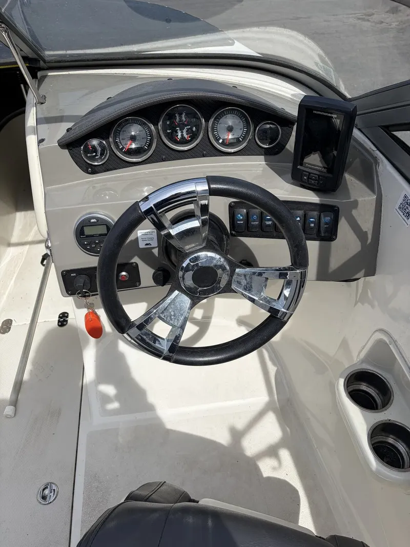 Slide: The Image of Dashboard of a 2018 Stingray 195 LX boat with steering wheel and gauges. - 3