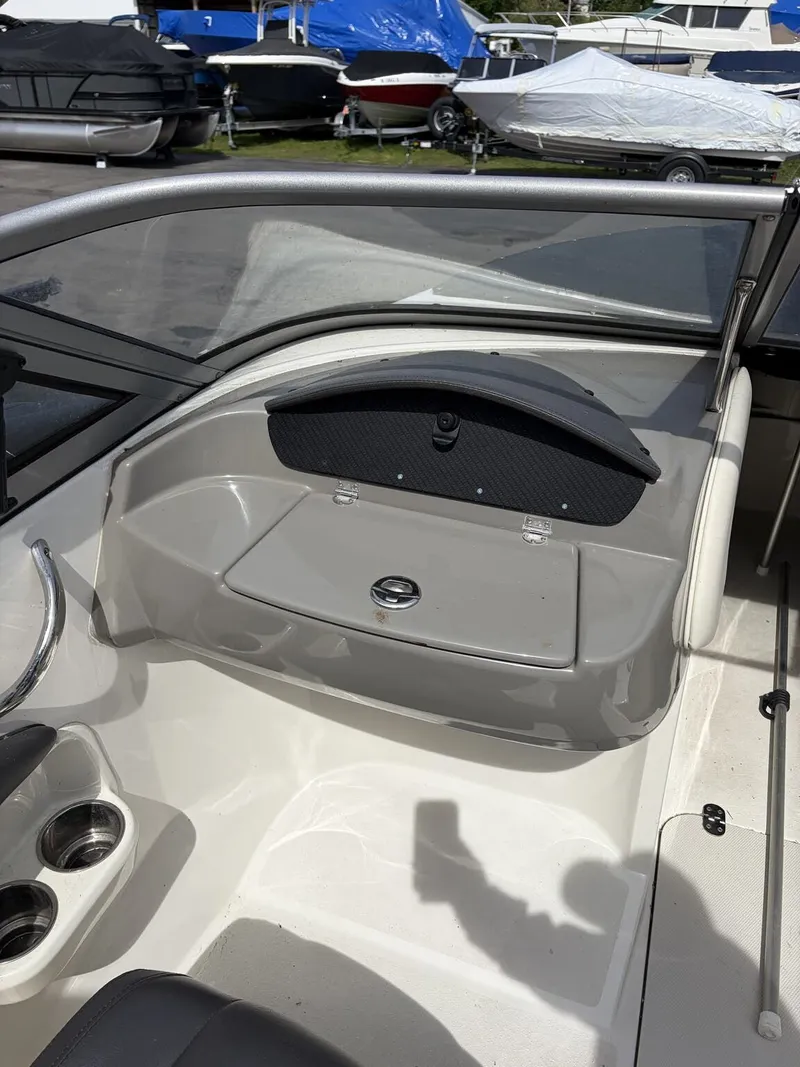 Slide: The Image of Interior of a 2018 Stingray 195 LX boat, featuring cup holders. - 4