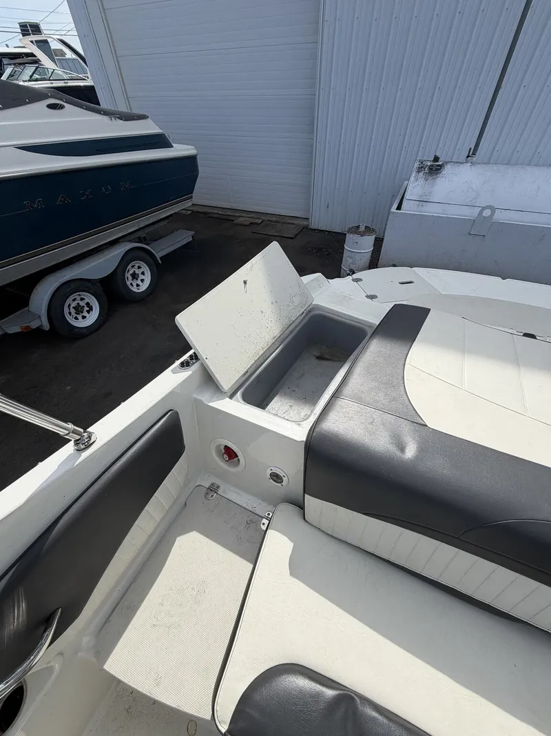 Slide: The Image of 2018 Stingray 195 LX boat with open storage compartment. - 6