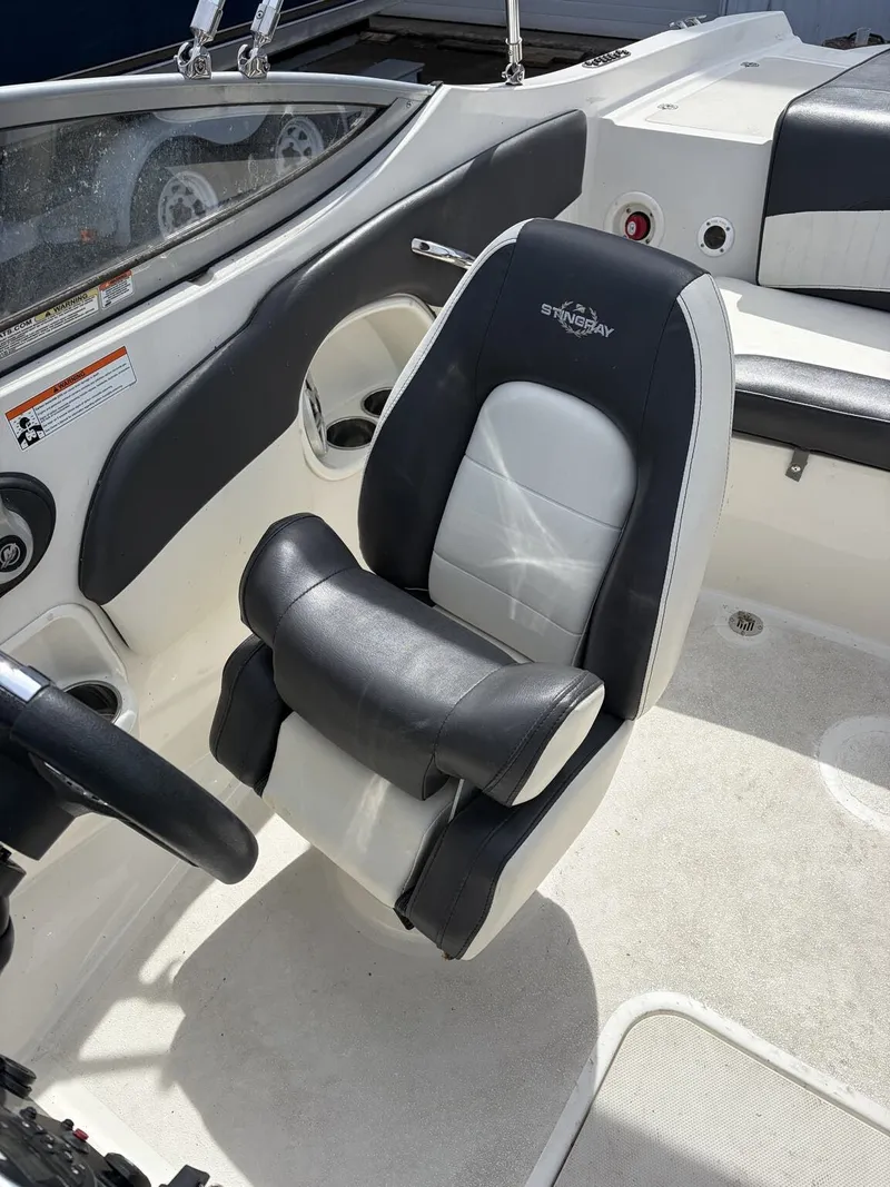 Slide: The Image of Interior of a 2018 Stingray 195 LX boat with black and white seating. - 8