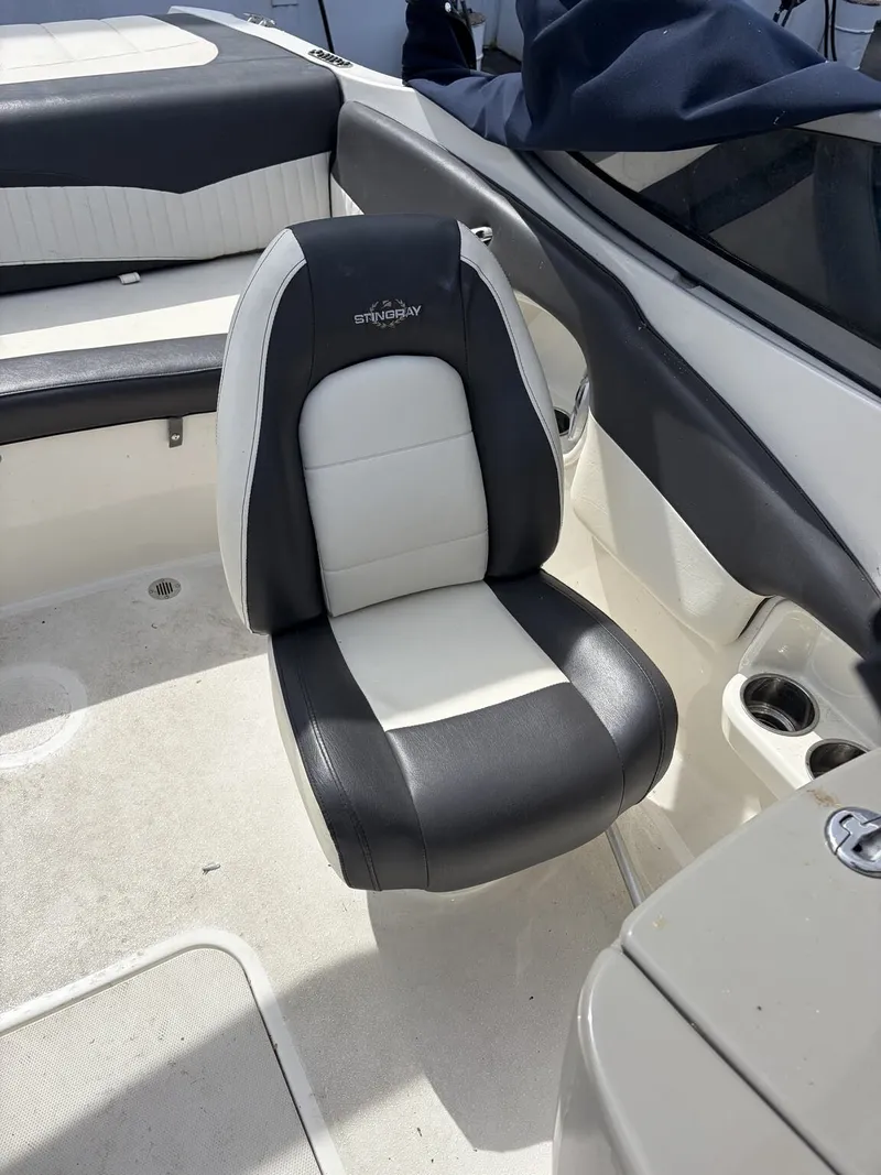 Slide: The Image of Interior of a 2018 Stingray 195 LX boat with black and white seating. - 9