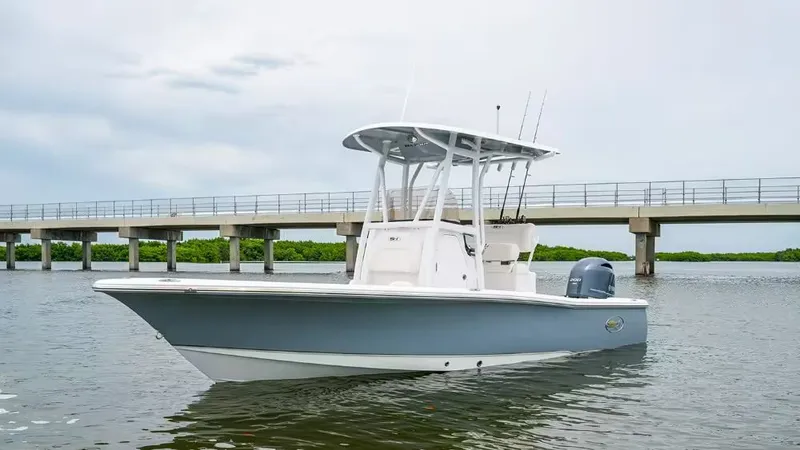 The Image of 2026 Sea Hunt BX 22 BR boat on calm water near bridge. - 1