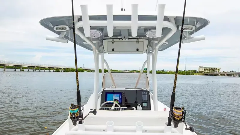 Slide: The Image of 2026 Sea Hunt BX 22 BR boat on calm water with fishing rods. - 14