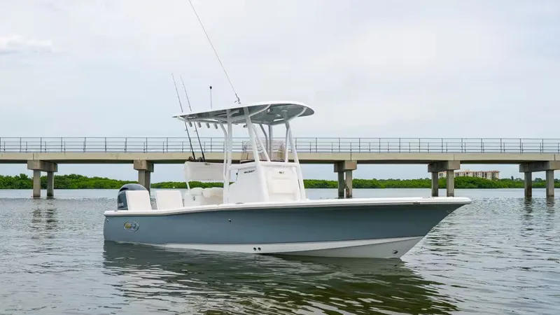 Slide: The Image of 2026 Sea Hunt BX 22 BR boat on calm water near bridge. - 2