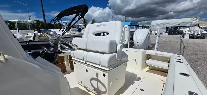 Slide: The Image of 2024 Pathfinder 2400 Open boat with white interior and helm station. - 12