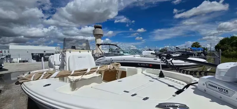 Slide: The Image of 2024 Pathfinder 2400 Open boat docked under sunny skies. - 18
