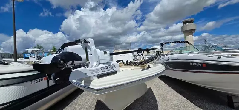 Slide: The Image of 2024 Pathfinder 2400 Open boat with Minn Kota motor, blue sky background. - 20