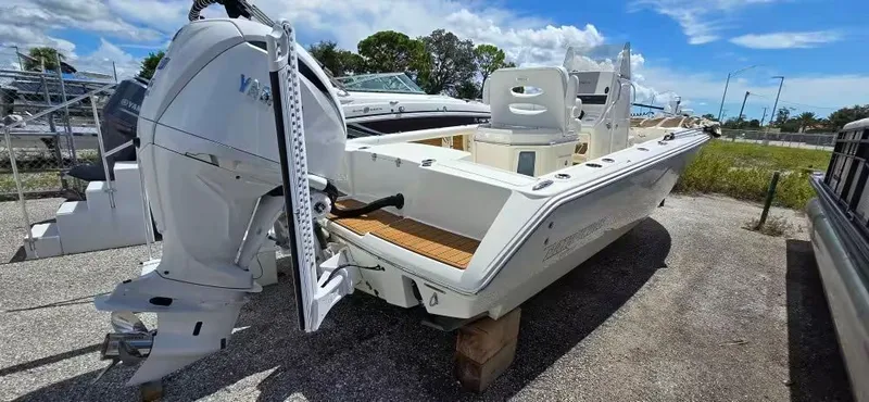 Slide: The Image of 2024 Pathfinder 2400 Open boat with outboard motor, parked on gravel. - 5