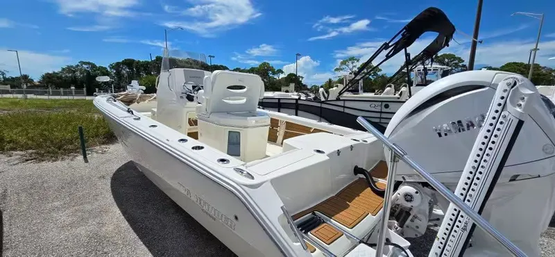 Slide: The Image of 2024 Pathfinder 2400 Open boat with Yamaha engine, parked on gravel. - 6