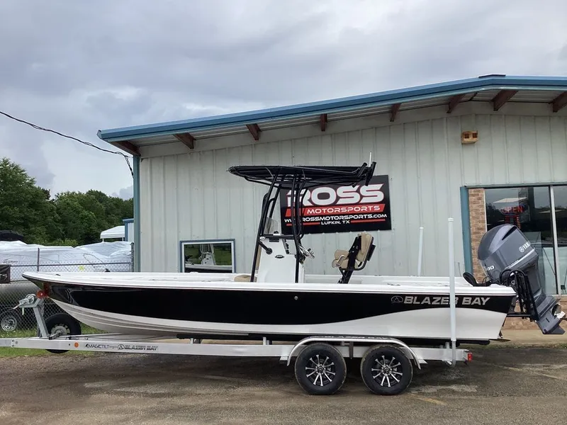 The Image of 2026 Blazer PureBay 2400 boat parked in front of a building. - 1